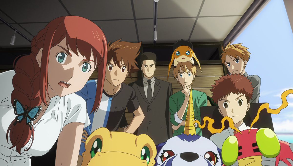 The Digimon cast, humans and Digimon together, all gather around to stare into the camera