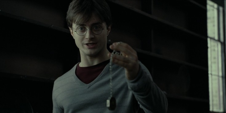 Harry-Potter-Harry-holds-Salazar-Slytherins-Necklace-now-a-horcrux-at-12-Grimmauld-Place-London.jpg